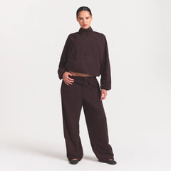 NikeSKIMS STRETCH NYLON OVERSIZED TRACK JACKET | DARK ROAST ON A MODEL FRONT VIEW @ | FOCUS: 0.0, 1.0, 0.9