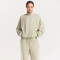 NikeSKIMS STRETCH NYLON OVERSIZED TRACK JACKET | TALC ON A MODEL SIDE VIEW @ | FOCUS: 0.0, 1.0, 0.9