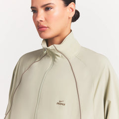 NikeSKIMS STRETCH NYLON OVERSIZED TRACK JACKET | TALC ON A MODEL SIDE VIEW @ | FOCUS: 0.0, 1.0, 0.9