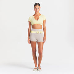 NikeSKIMS PERFORMANCE COTTON BLEND SHORT SLEEVE V-NECK TOP | BICYCLE YELLOW ON A MODEL FRONT VIEW @ | FOCUS: 0.0, 1.0, 0.9