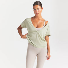 NikeSKIMS PERFORMANCE COTTON BLEND SHORT SLEEVE V-NECK TOP | TALC ON A MODEL SIDE VIEW @ | FOCUS: 0.0, 1.0, 0.9