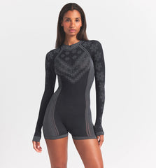 SKIMS FIRST LAYERS HALF ZIP ONESIE | OBSIDIAN WINTER FAIR ISLE ON A MODEL SIDE VIEW @ | FOCUS: 0.0, 1.0, 0.9