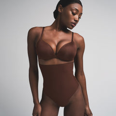 SKIMS BODY CORE SCULPT HIGH-WAISTED THONG | COCOA ON A MODEL FRONT VIEW