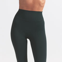 NikeSKIMS MATTE KNEE GRIP 26" LEGGING | DARK TEAL ON A MODEL SIDE VIEW @ | FOCUS: 0.0, 1.0, 0.9