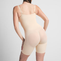 SEAMLESS SCULPT BUTT LIFTING OPEN BUST BODYSUIT | SAND ON A MODEL BACK VIEW