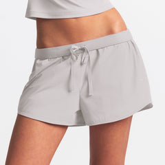 NikeSKIMS WOVEN NYLON 2.5" RUNNER SHORT | STONE ON A MODEL FRONT VIEW @ | FOCUS: 0.9, 0.1, 0.7