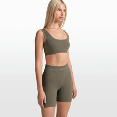 NikeSKIMS RIBBED SEAMLESS 5" BIKER SHORT | DUSTY OAKMOSS ON A MODEL FRONT VIEW @ | FOCUS: 0.0, 1.0, 0.9