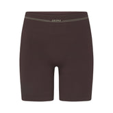 NikeSKIMS RIBBED SEAMLESS 5" BIKER SHORT | PHOENIX/TRUFFLE FLAT ON A WHITE BACKGROUND | FLT