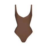 SKIMS BODY UNLINED PLUNGE THONG BODYSUIT | JASPER (SHAPEWEAR BODYSUITS, SHAPEWEAR) LAYS FLAT ON A WHITE BACKGROUND | FLT