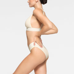 COTTON PLUNGE BRALETTE WORN BY A MODEL IN SIDE VIEW