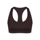NikeSKIMS SHINE RACER BACK BRA | PHOENIX FLAT ON A WHITE BACKGROUND | FLT
