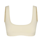 NikeSKIMS RIBBED SEAMLESS MICRO SCOOP BRA | LEMON DROP & LAYS FLAT ON A WHITE BACKGROUND | FLT