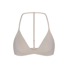 NikeSKIMS STUDIO STRETCH T-BACK TRIANGLE BRA | LINEN LAYS FLAT ON A WHITE BACKGROUND | FLT