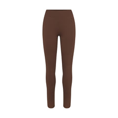 NikeSKIMS MATTE 26" LEGGING | DARK SEPIA FLAT ON A WHITE BACKGROUND | FLT