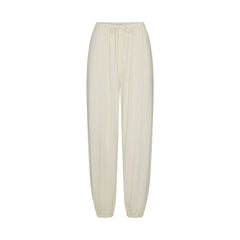 SKIMS SLEEP JOGGER | ECRU FLAT ON A WHITE BACKGROUND | FLT