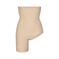 SKIMS BODY LEFT LEG SOLUTION SHORT | SAND FLAT ON A WHITE BACKGROUND | FLT