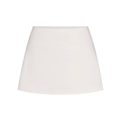 NikeSKIMS MATTE SKORT | IVORY LAYS FLAT ON A WHITE BACKGROUND | FLT