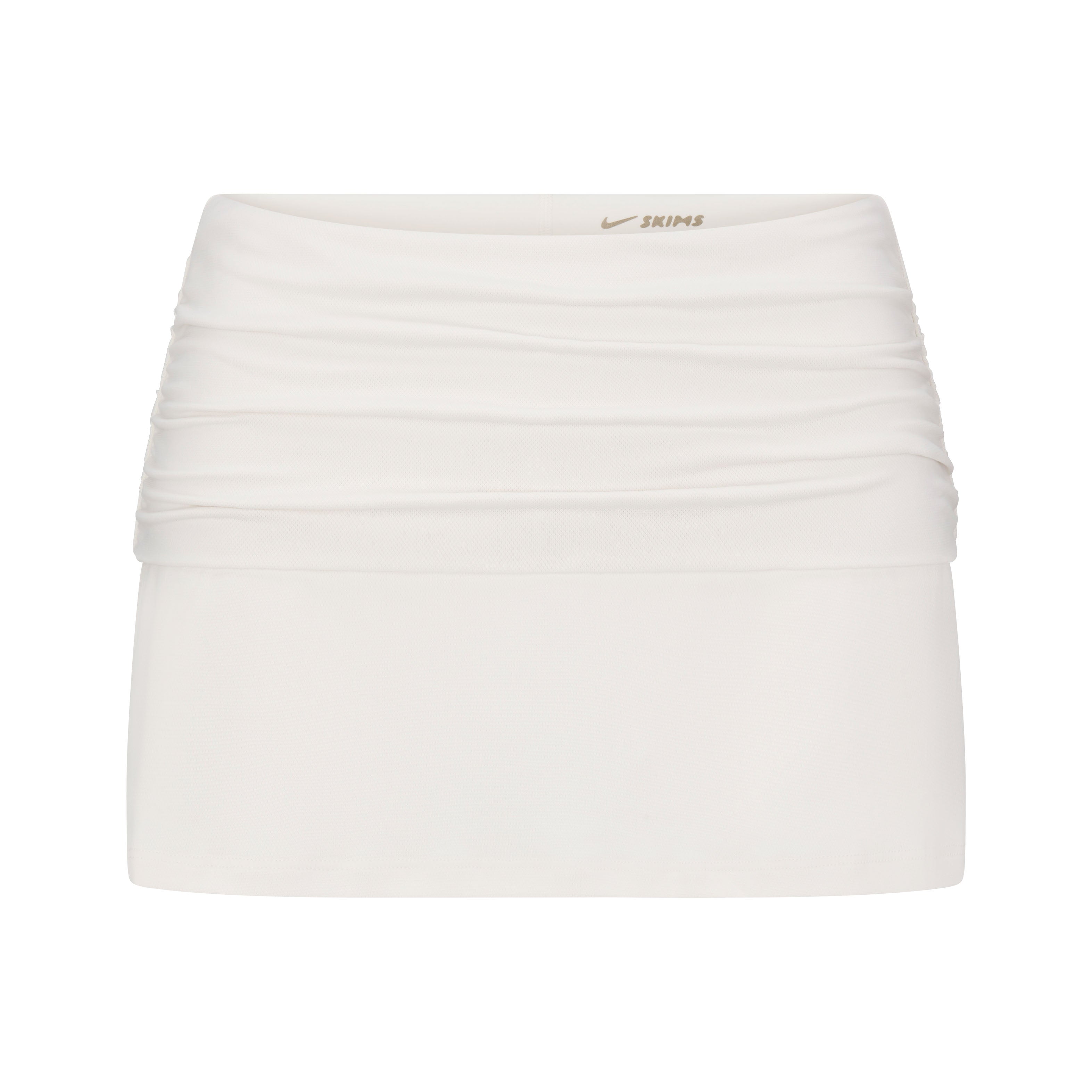 NikeSKIMS AIRY FOLDOVER SKORT | IVORY LAYS FLAT ON A WHITE BACKGROUND | FLT