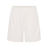NikeSKIMS AIRY RELAXED SHORT | IVORY LAYS FLAT ON A WHITE BACKGROUND | FLT