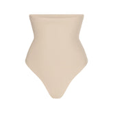 SKIMS BODY CORE SCULPT HIGH-WAISTED THONG | SAND FLAT ON A WHITE BACKGROUND | FLT | FLT
