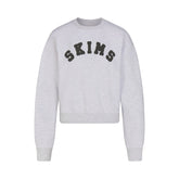 COTTON FLEECE CLASSIC CREWNECK | LIGHT HEATHER GREY WITH ONYX LOGO FLAT ON A WHITE BACKGROUND | FLT