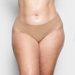 ON A MODEL FRONT VIEW FREE CUT MID WAIST TANGA IN CLAY | FOCUS: 0.1, 0.9, 0.9