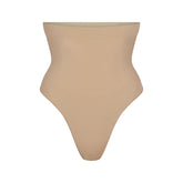 SEAMLESS SCULPT HIGH-WAISTED THONG | CLAY (SHAPEWEAR THONGS, PANTIES) LAYS FLAT ON A WHITE BACKGROUND | FLT