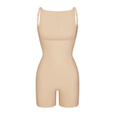 SKIMS BODY CORE SCULPT BACK SMOOTHING OPEN BUST MID THIGH BODYSUIT | SAND FLAT ON A WHITE BACKGROUND | FLT