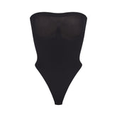 SEAMLESS SCULPT STRAPLESS THONG BODYSUIT | ONYX (SHAPEWEAR BODYSUITS) LAYS FLAT ON A WHITE BACKGROUND | FLT