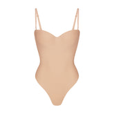 SKIMS BODY UNDERWIRE THONG BODYSUIT | CLAY (SHAPEWEAR BODYSUITS, SHAPEWEAR) LAYS FLAT ON A WHITE BACKGROUND | FLT