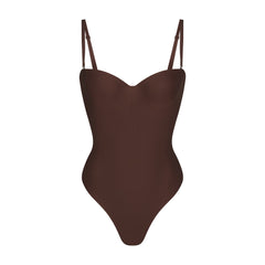 SKIMS BODY UNDERWIRE THONG BODYSUIT | COCOA (SHAPEWEAR BODYSUITS, SHAPEWEAR) LAYS FLAT ON A WHITE BACKGROUND | FLT