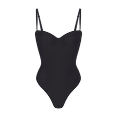 SKIMS BODY UNDERWIRE THONG BODYSUIT | ONYX (SHAPEWEAR BODYSUITS, SHAPEWEAR) LAYS FLAT ON A WHITE BACKGROUND | FLT