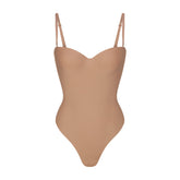 SKIMS BODY UNDERWIRE THONG BODYSUIT | SIENNA (SHAPEWEAR BODYSUITS, SHAPEWEAR) LAYS FLAT ON A WHITE BACKGROUND | FLT