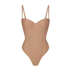 SKIMS BODY UNDERWIRE THONG BODYSUIT | SIENNA (SHAPEWEAR BODYSUITS, SHAPEWEAR) LAYS FLAT ON A WHITE BACKGROUND | FLT