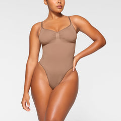 SEAMLESS SCULPT THONG BODYSUIT WORN BY A MODEL IN FRONT VIEW, XL
