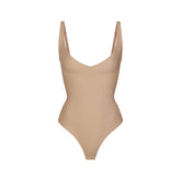 SKIMS BODY CORE SCULPT PLUNGE THONG BODYSUIT | CLAY (SHAPEWEAR BODYSUITS) FLAT ON A WHITE BACKGROUND | FLT