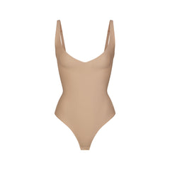 SKIMS BODY CORE SCULPT PLUNGE THONG BODYSUIT | CLAY (SHAPEWEAR BODYSUITS) FLAT ON A WHITE BACKGROUND | FLT