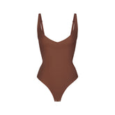 SKIMS BODY CORE SCULPT PLUNGE THONG BODYSUIT | JASPER (SHAPEWEAR BODYSUITS) FLAT ON A WHITE BACKGROUND | FLT