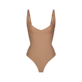 SKIMS BODY CORE SCULPT PLUNGE THONG BODYSUIT | SIENNA (SHAPEWEAR BODYSUITS) FLAT ON A WHITE BACKGROUND | FLT