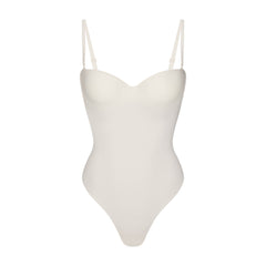 SKIMS BODY UNDERWIRE THONG BODYSUIT | IVORY FLAT ON A WHITE BACKGROUND | FLT