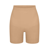 SEAMLESS SCULPT MID THIGH SHORT | CLAY (SHAPEWEAR SHORTS, SHAPEWEAR) LAYS FLAT ON A WHITE BACKGROUND | FLT