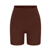 SEAMLESS SCULPT MID THIGH SHORT | COCOA (SHAPEWEAR SHORTS, SHAPEWEAR) LAYS FLAT ON A WHITE BACKGROUND | FLT
