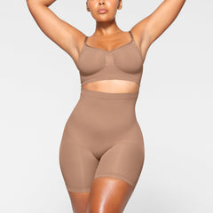 SEAMLESS SCULPT MID THIGH SHORT WORN BY A MODEL IN FRONT VIEW, XL