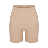SEAMLESS SCULPT MID THIGH SHORT | MICA (SHAPEWEAR SHORTS, SHAPEWEAR) LAYS FLAT ON A WHITE BACKGROUND | FLT