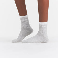 RIBBED QUARTER CREW LOGO SOCK | LIGHT HEATHER GREY AND SNOW ON A MODEL | FOCUS: 0.0, 1.0, 0.9