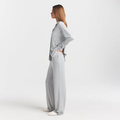 SKIMS SLEEP LONG SLEEVE BUTTON UP SET | LIGHT HEATHER GREY ON A MODEL SIDE VIEW @ | FOCUS: 0.0, 1.0, 0.9