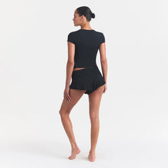 SKIMS SLEEP HENLEY AND FOLDOVER SHORT SET | ONYX ON A MODEL FRONT VIEW @ | FOCUS: 0.0, 1.0, 0.9