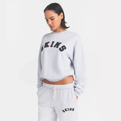 COTTON FLEECE CLASSIC CREWNECK | LIGHT HEATHER GREY WITH ONYX LOGO ON A MODEL SIDE VIEW @ | FOCUS: 0.0, 1.0, 0.9
