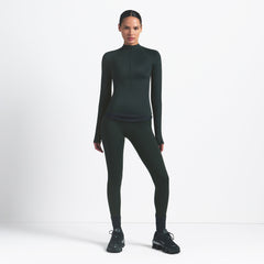 NikeSKIMS SHINE LONG SLEEVE HALF ZIP | DARK TEAL ON A MODEL SIDE VIEW @ | FOCUS: 0.0, 1.0, 0.9