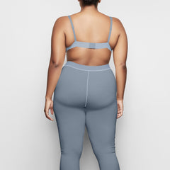 COTTON RIB LEGGING IS SHOWN ON A MODEL POSING IN STYLISTIC CAMPAIGN IMAGERY